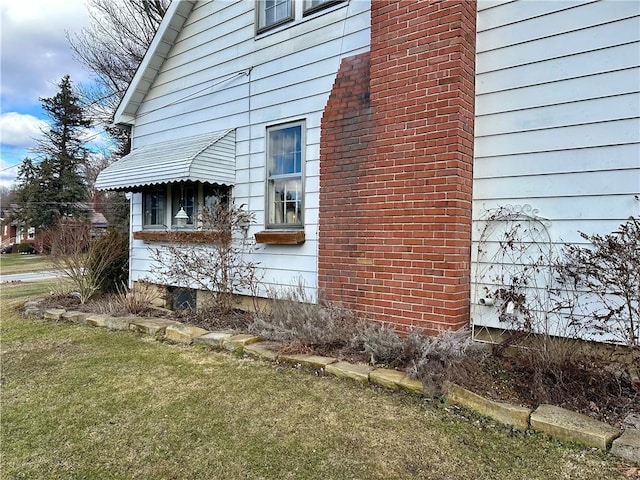 view of property exterior with a lawn