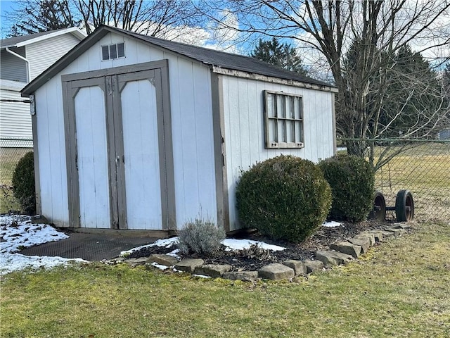 view of shed with fence