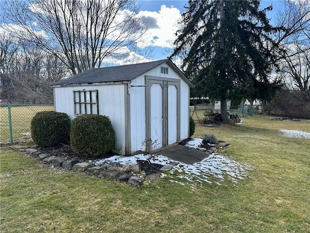 view of shed featuring fence