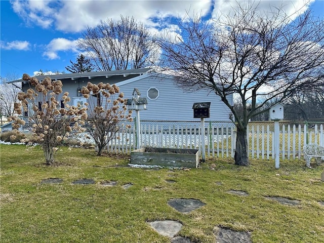 view of yard with a vegetable garden and fence