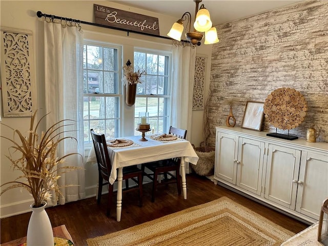 dining room featuring a chandelier and dark wood-style floors