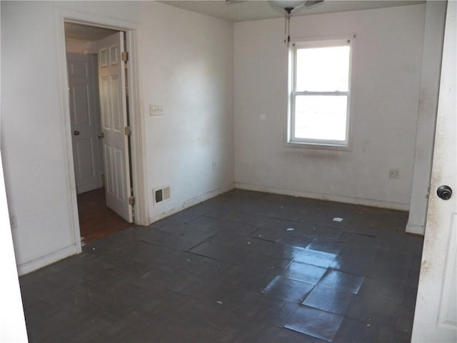 spare room featuring visible vents and baseboards