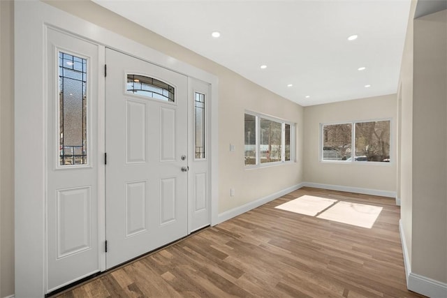 entryway featuring recessed lighting, wood finished floors, and baseboards