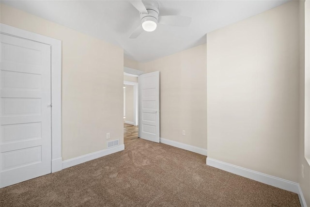 unfurnished bedroom with visible vents, carpet floors, baseboards, and ceiling fan