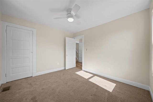 unfurnished bedroom with visible vents, baseboards, carpet, and a ceiling fan