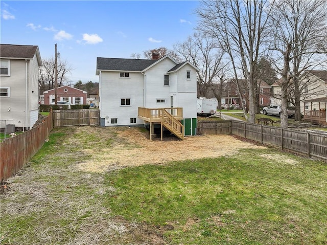 back of house with a residential view, cooling unit, a chimney, a yard, and a fenced backyard