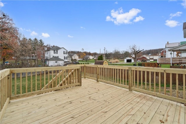 wooden deck with a yard and a residential view