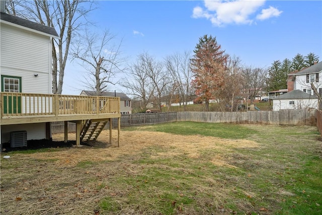 view of yard with central air condition unit, a wooden deck, stairs, and a fenced backyard