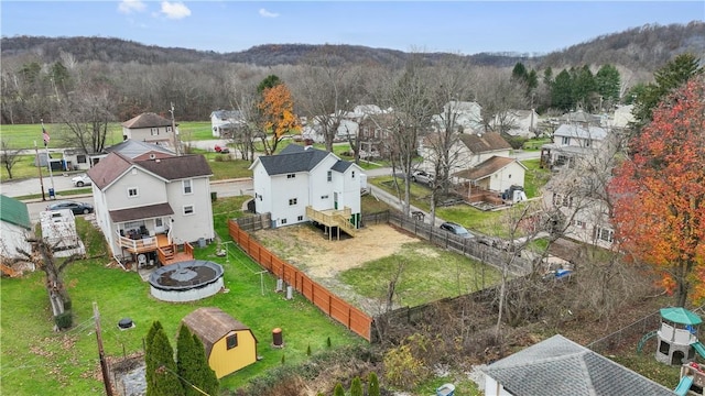 bird's eye view featuring a wooded view and a residential view