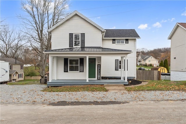 view of front of house featuring a porch and fence