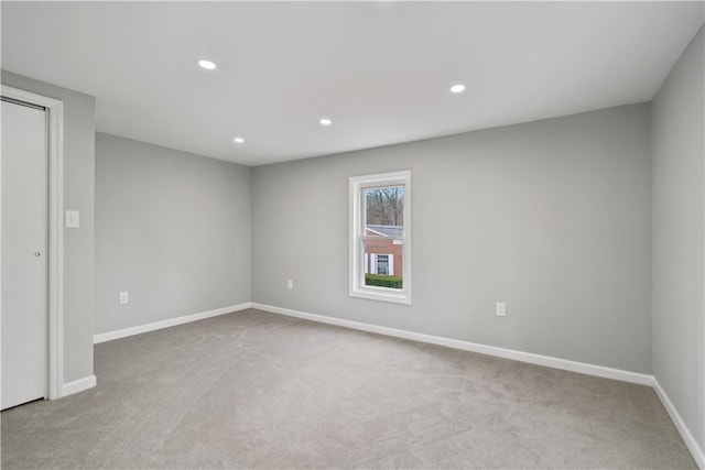 carpeted empty room with recessed lighting and baseboards