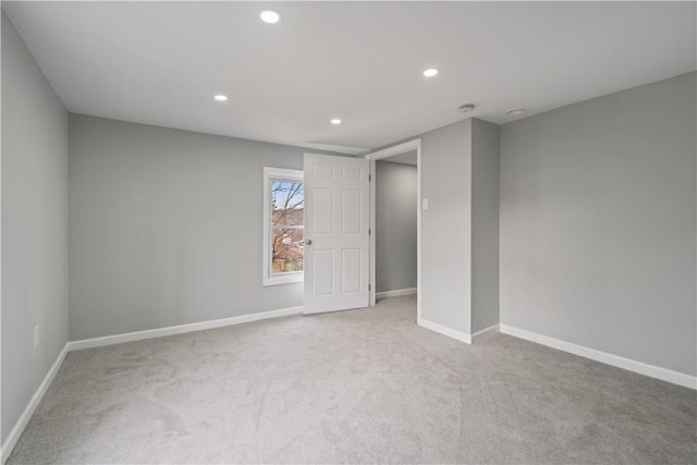 carpeted spare room featuring recessed lighting and baseboards