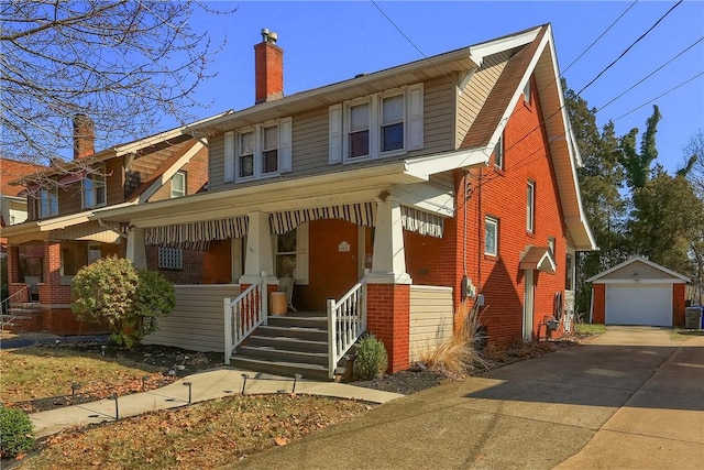 view of front of home featuring brick siding, a porch, a chimney, an outdoor structure, and driveway