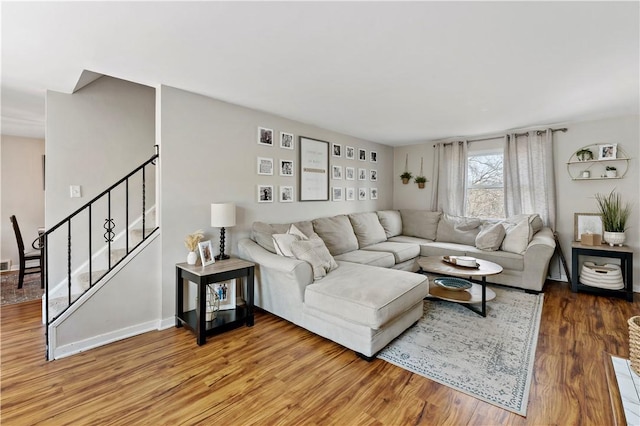 living area featuring stairs and wood finished floors