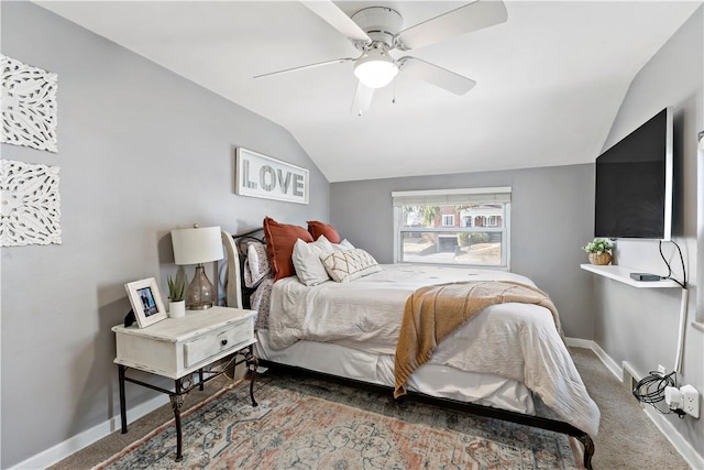 carpeted bedroom with baseboards, lofted ceiling, and a ceiling fan