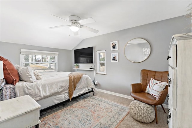 carpeted bedroom with a ceiling fan, baseboards, and vaulted ceiling