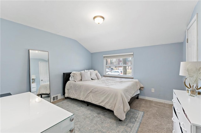 bedroom featuring light carpet, visible vents, baseboards, and lofted ceiling