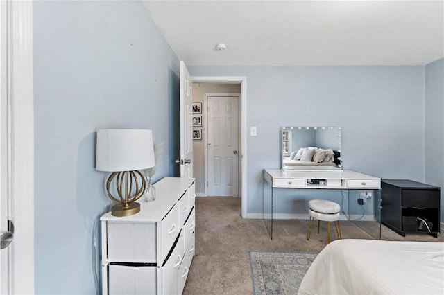 bedroom featuring light colored carpet and baseboards