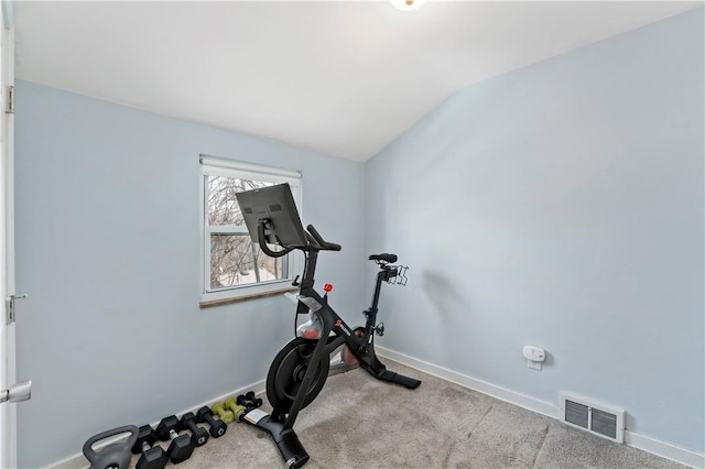 exercise area with visible vents, carpet floors, baseboards, and vaulted ceiling