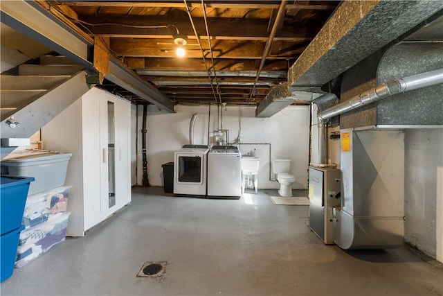 unfinished below grade area with heating unit, separate washer and dryer, and a sink