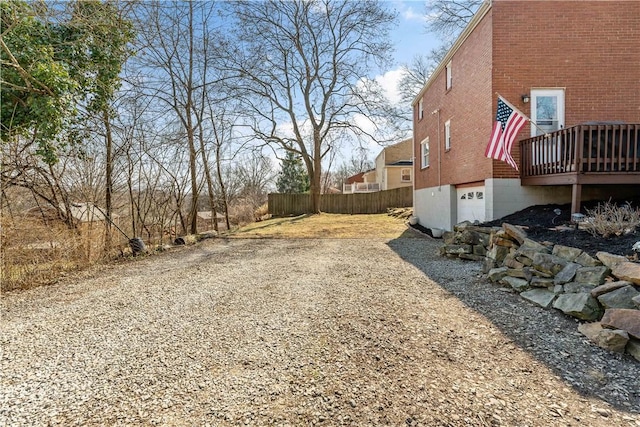 view of yard with fence and a garage