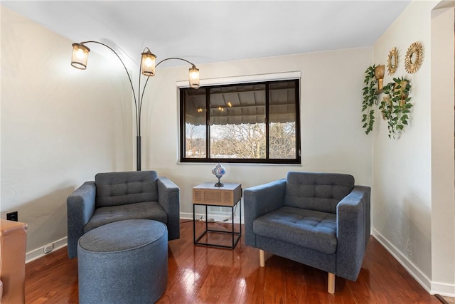 sitting room with hardwood / wood-style floors and baseboards