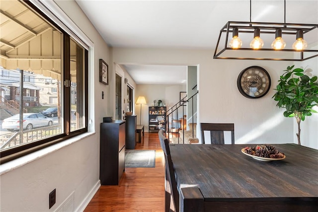 dining room featuring stairs and wood finished floors