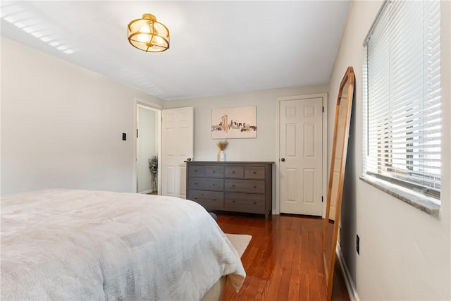 bedroom with dark wood-style flooring