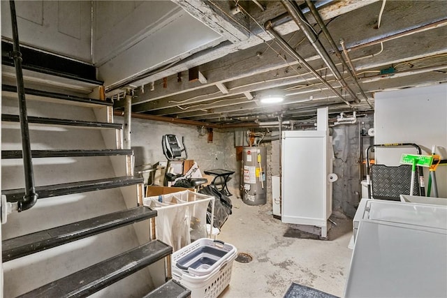 unfinished basement featuring washing machine and clothes dryer and gas water heater