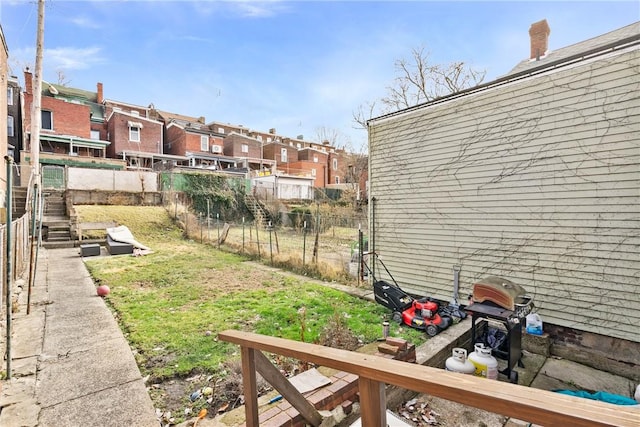 view of yard with a residential view and fence