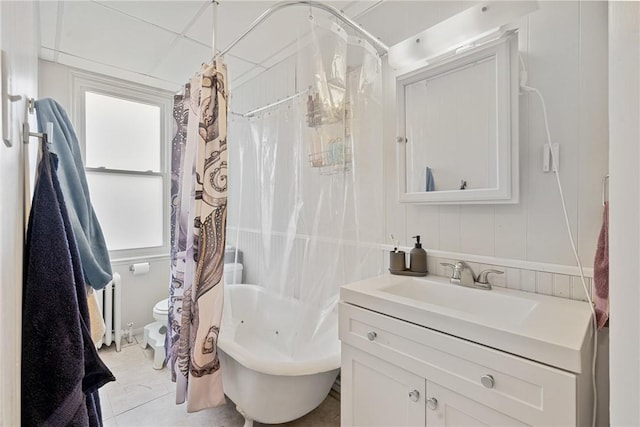 full bath with toilet, radiator, vanity, and shower / tub combo with curtain