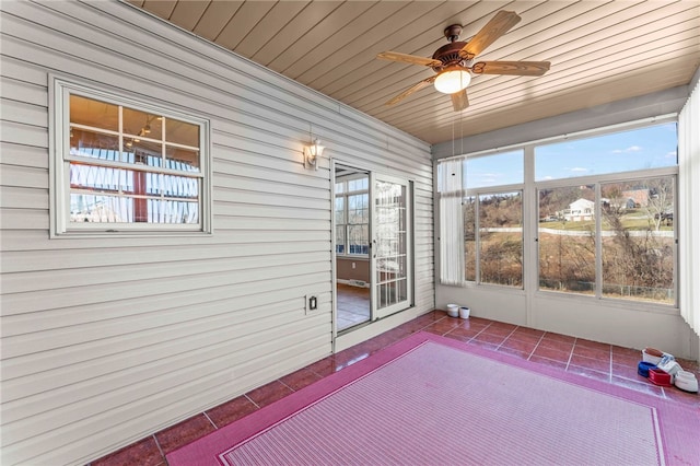 unfurnished sunroom with a wealth of natural light and a ceiling fan