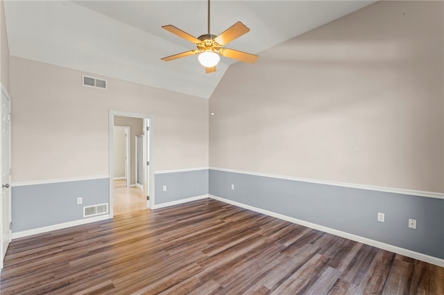 unfurnished room with ceiling fan, visible vents, wood finished floors, and vaulted ceiling