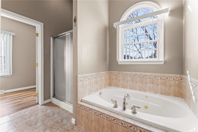 bathroom featuring visible vents, a jetted tub, baseboards, a stall shower, and tile patterned floors