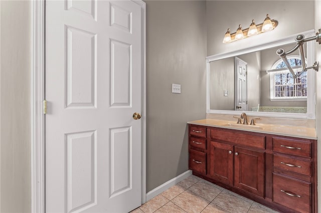 bathroom featuring tile patterned floors, vanity, and baseboards