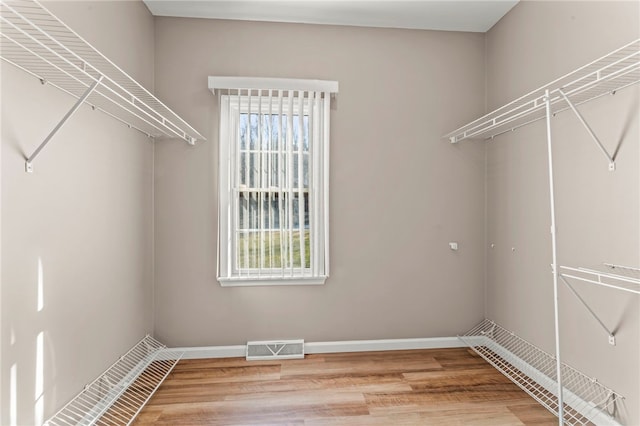 walk in closet featuring visible vents and light wood-type flooring