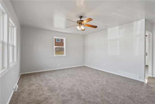 unfurnished room featuring visible vents, baseboards, carpet, and ceiling fan