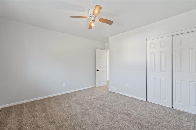 unfurnished bedroom featuring visible vents, baseboards, ceiling fan, a closet, and carpet flooring