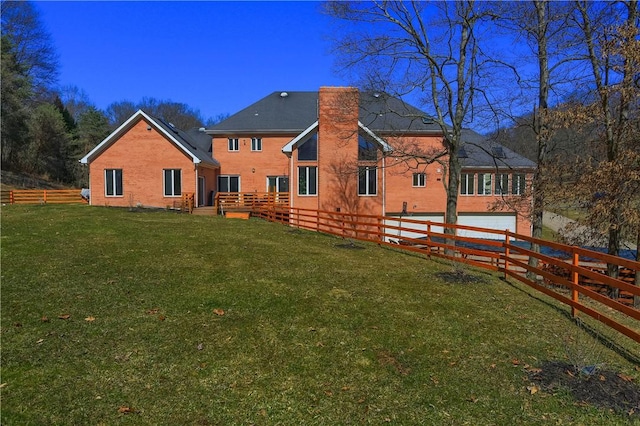 back of house featuring a garage, a lawn, a chimney, and fence