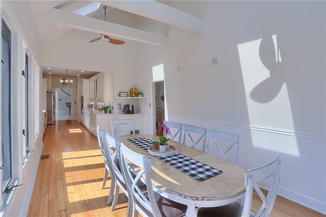 dining space featuring visible vents, high vaulted ceiling, light wood-style flooring, beamed ceiling, and a notable chandelier