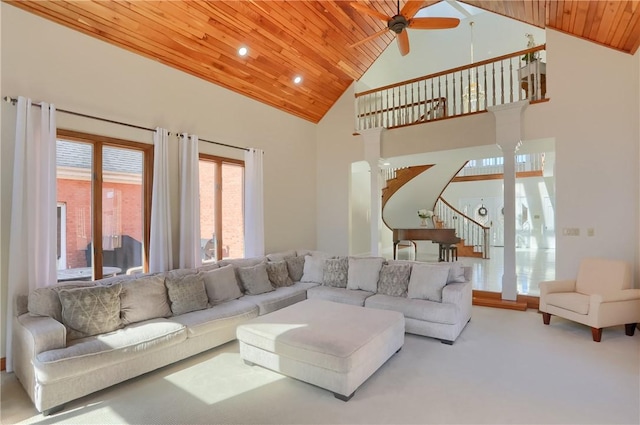 living room with ceiling fan, stairway, carpet flooring, wooden ceiling, and high vaulted ceiling