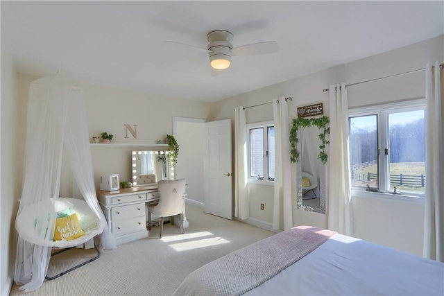 bedroom featuring access to exterior, carpet flooring, and a ceiling fan