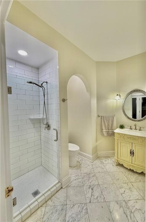 full bath featuring vanity, baseboards, a shower stall, toilet, and marble finish floor