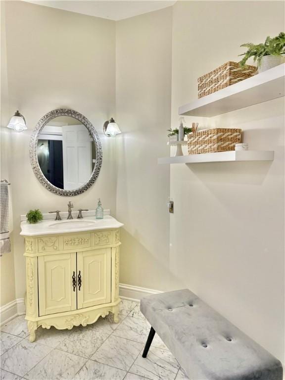 bathroom with vanity, baseboards, and marble finish floor