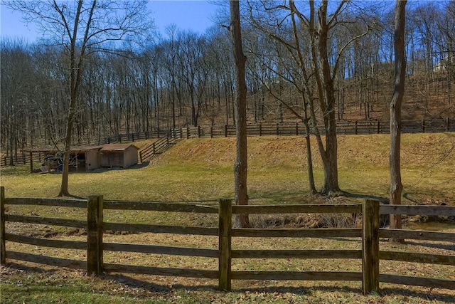 view of yard featuring a rural view and an outdoor structure