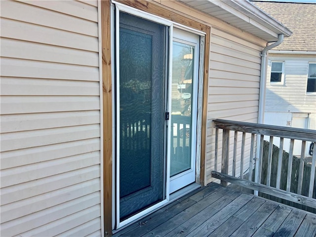 doorway to property with roof with shingles