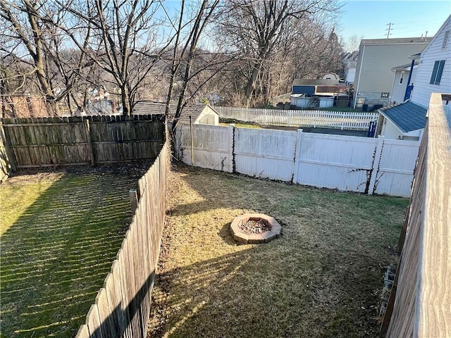 view of yard with an outdoor fire pit and a fenced backyard