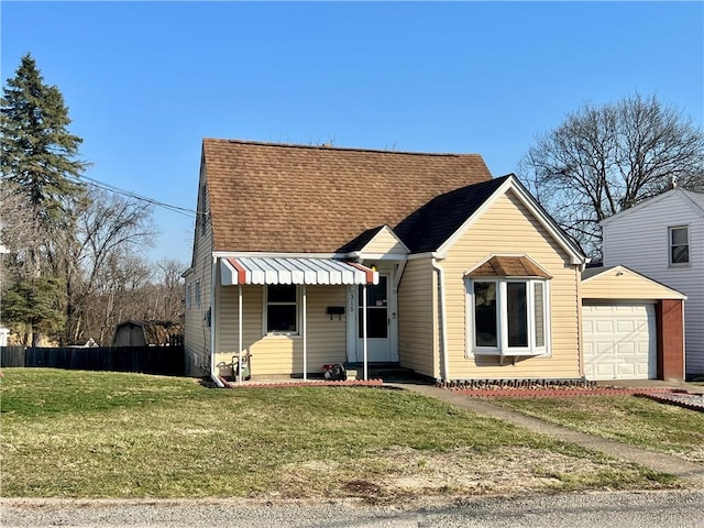 bungalow-style house featuring a shingled roof, a front lawn, and fence