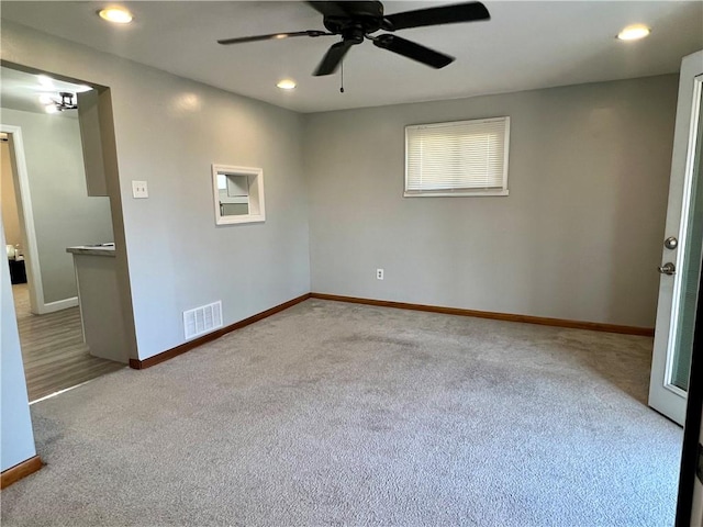 carpeted empty room with visible vents, recessed lighting, baseboards, and ceiling fan