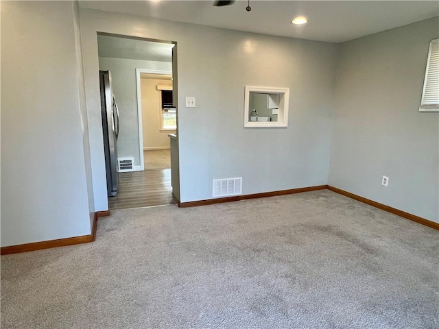 carpeted empty room featuring recessed lighting, baseboards, and visible vents